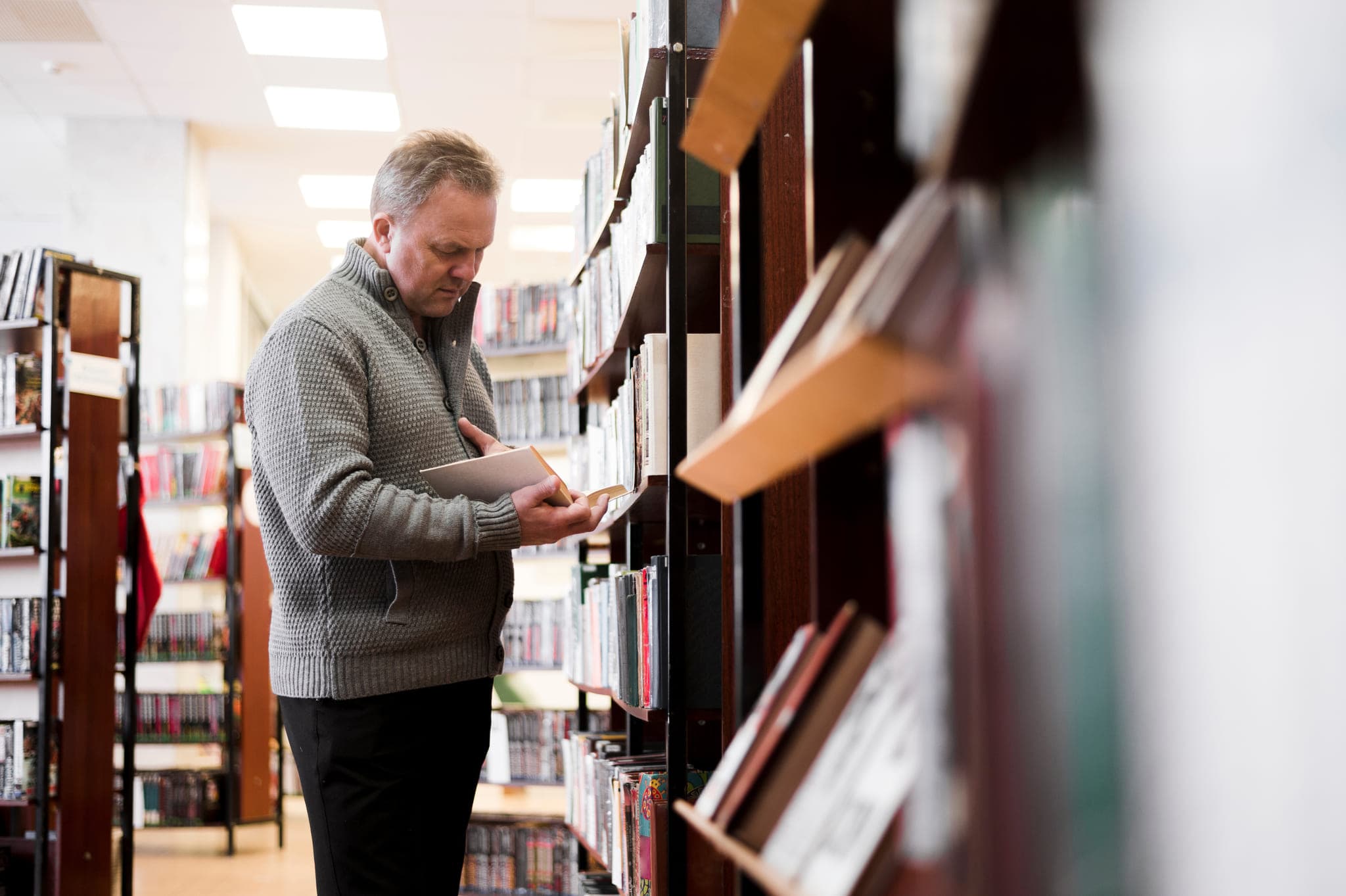Bookseller reviewing a book in store