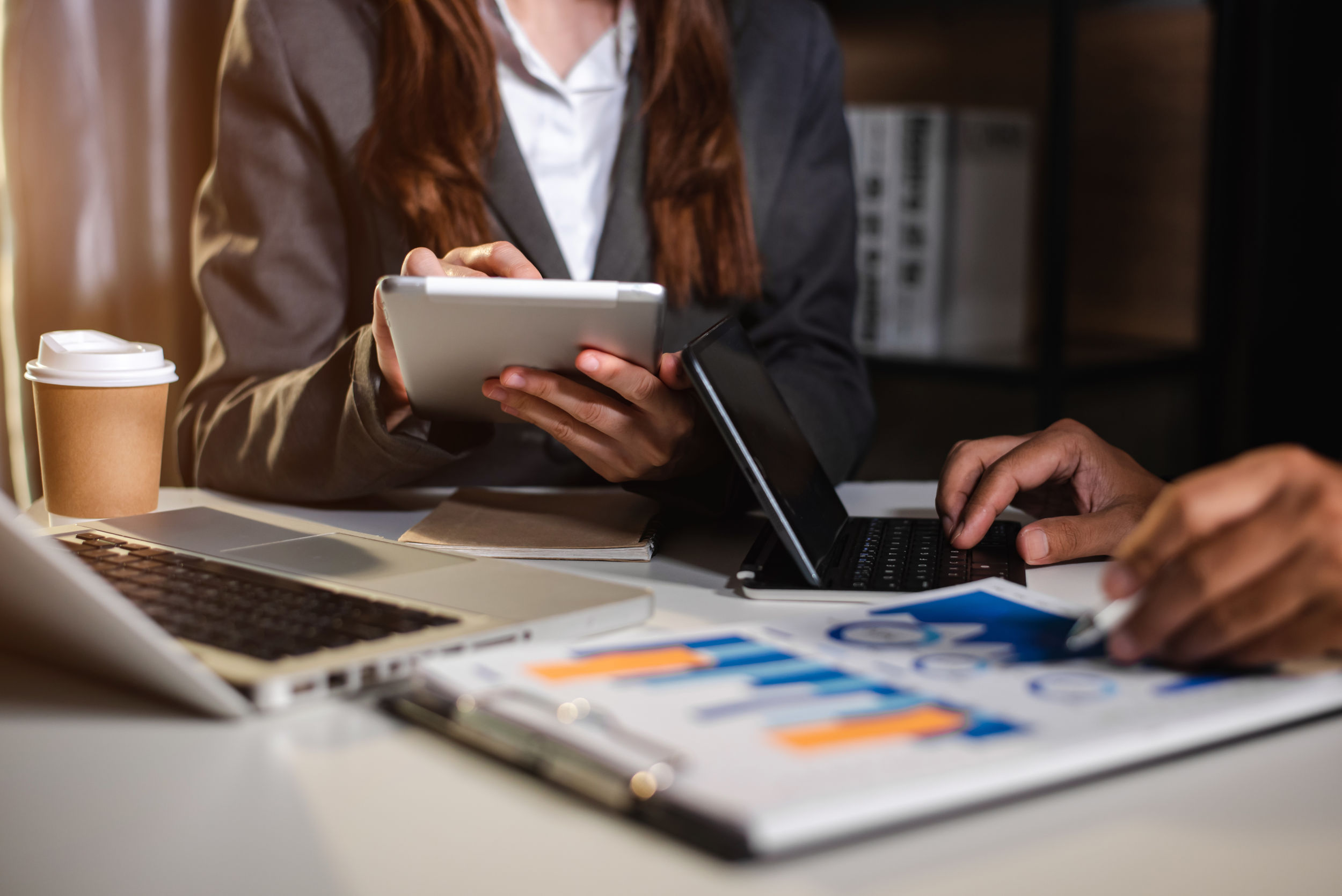 Business people discussing with financial documents and charts